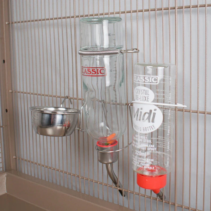 Two bottles and a stainless steel bowl hanging in a cage