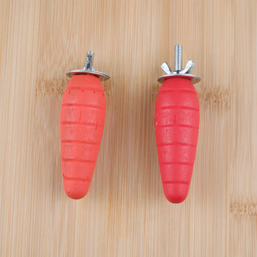 Two carrot chews with metal fixings on a wooden background