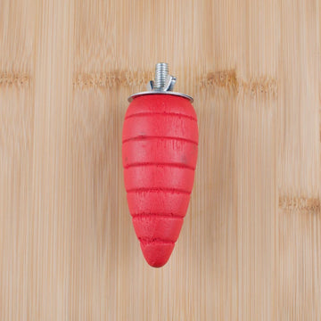 Red carrot-shaped object with a metal screw on a wooden background