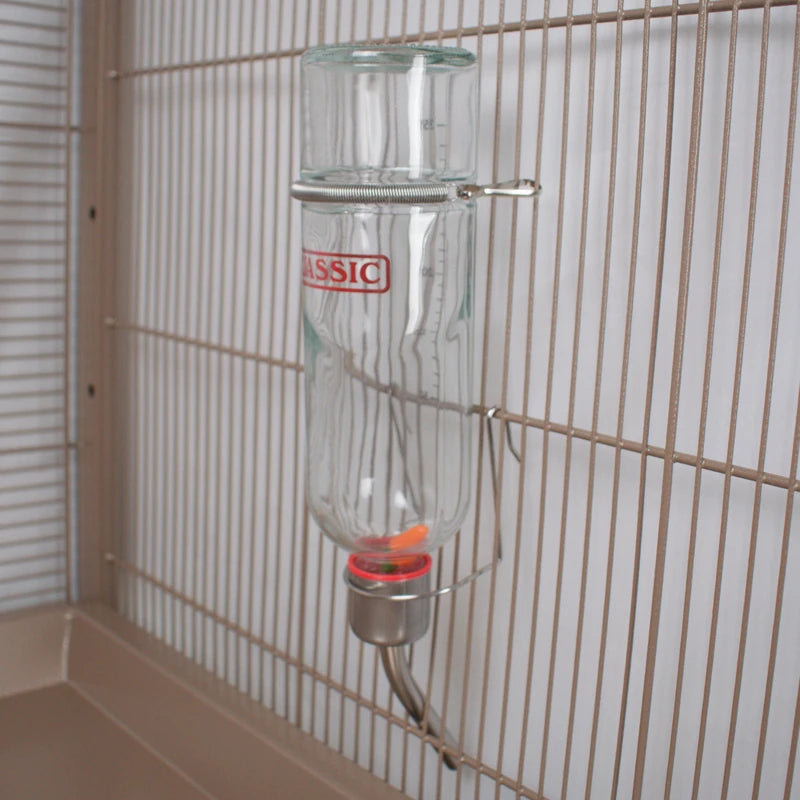 Clear feeder with 'Classic' label attached to a wire cage