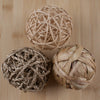 Three woven balls on a wooden surface